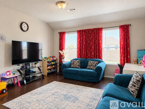 A living room with a blue couch and a television.