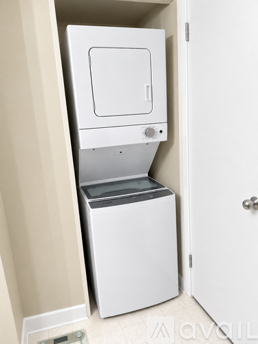A white dishwasher is built into a wall in a kitchen.