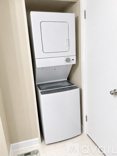 A white dishwasher is built into a wall in a kitchen.