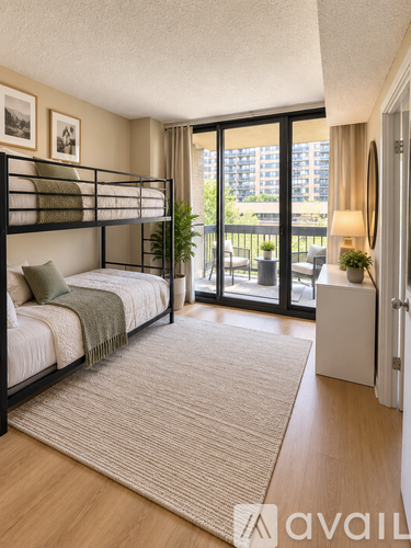 A bedroom with a bunk bed and a balcony.