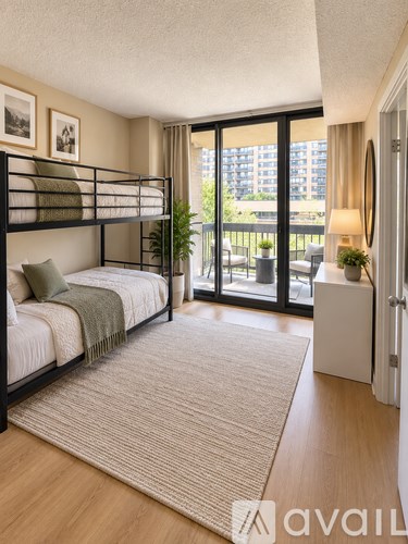 A bedroom with a bunk bed and a balcony.