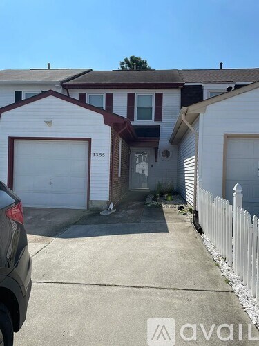 A white house with a garage door numbered 1335.