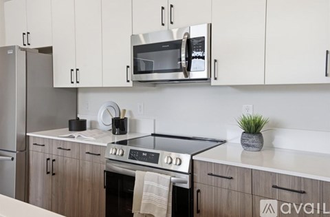 A kitchen with a stove top oven and a microwave above it.