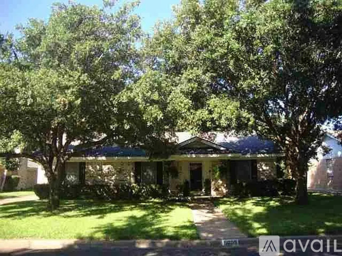 A house with a tree in front of it is for sale.