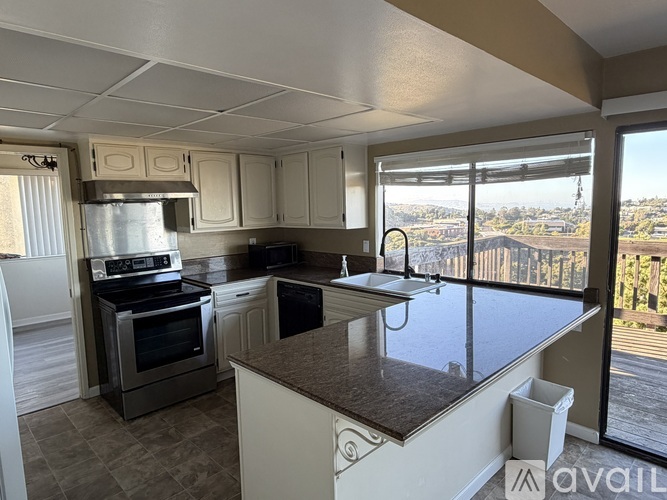 A kitchen with a stove top oven and a dishwasher.