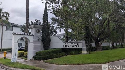 A sign for Villas de Tuscany is displayed in front of a building.