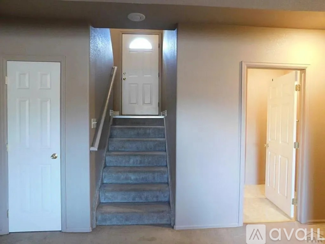 A staircase with a light on the top and a door on the right.