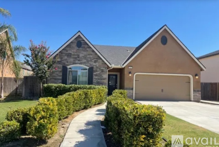 A house with a driveway and a garage is for sale.