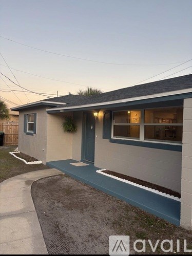 A house with a blue door and a small front yard.