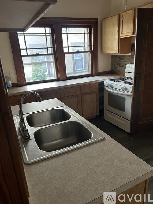 A kitchen with a double sink and a window.