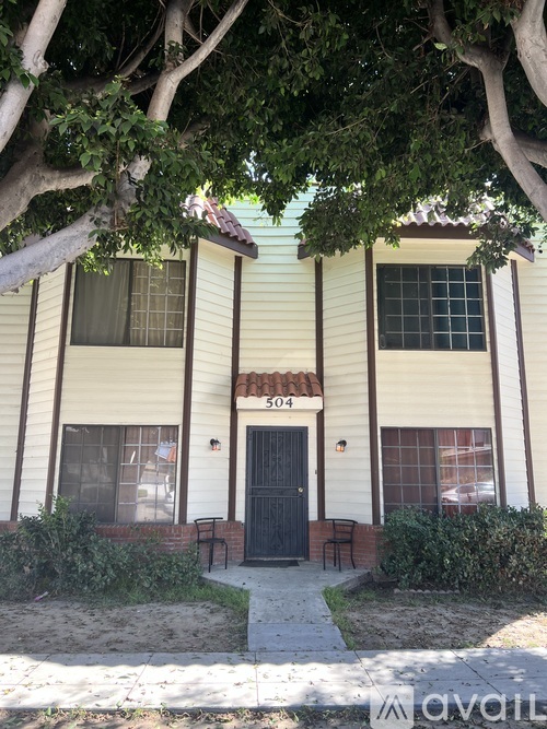 A two-story house with a black door and windows.