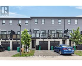 A modern two-story apartment building with balconies and a car parked in front.