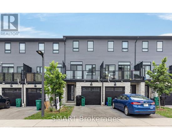 A modern two-story apartment building with balconies and a car parked in front.