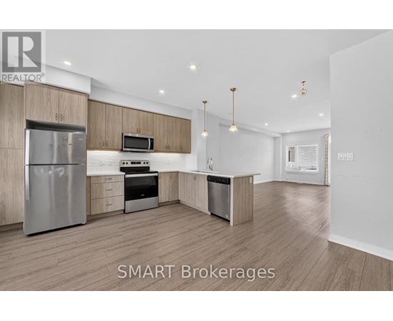 A modern kitchen with wooden cabinets and stainless steel appliances.
