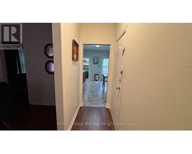 A hallway with a door on the right and a wall on the left.