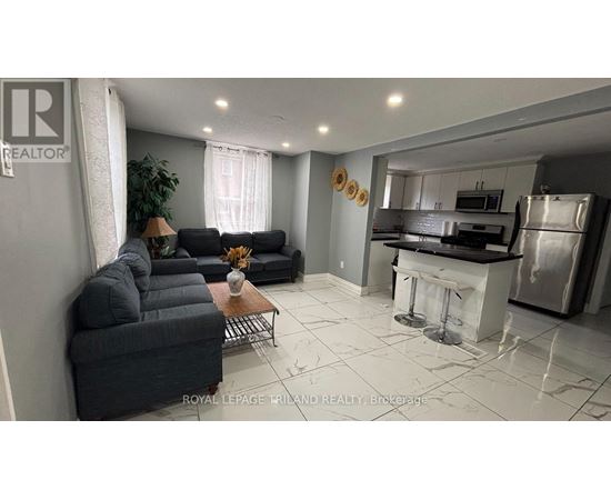 A living room with a black couch and a coffee table.