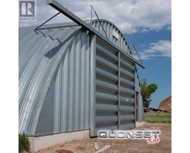 A large metal storage shed with the name "QUONSET" on the side.