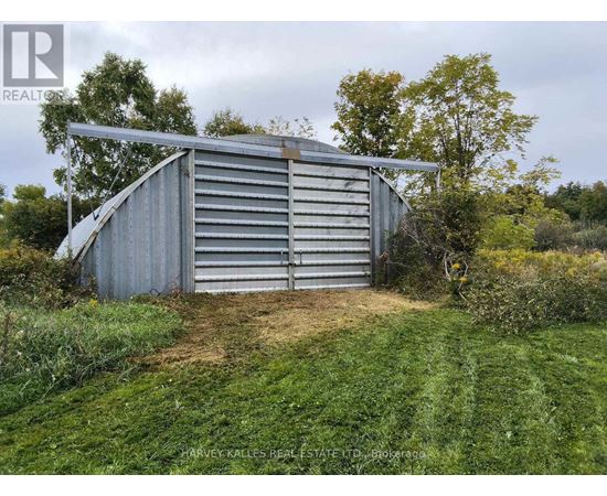 A large metal storage shed with the name "QUONSET" on the side.