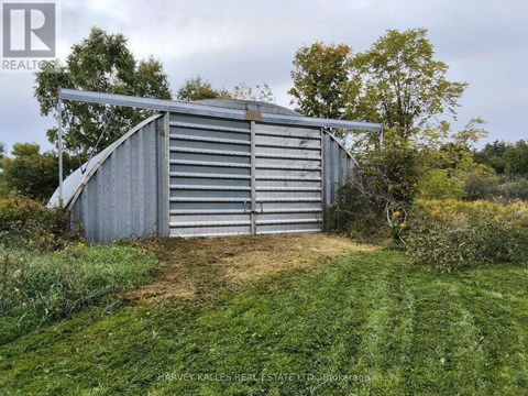 A large metal storage shed with the name "QUONSET" on the side.