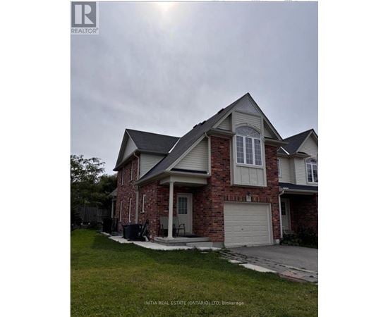 A house with a brick facade and a white garage door.