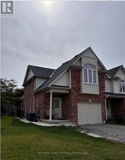 A house with a brick facade and a white garage door.