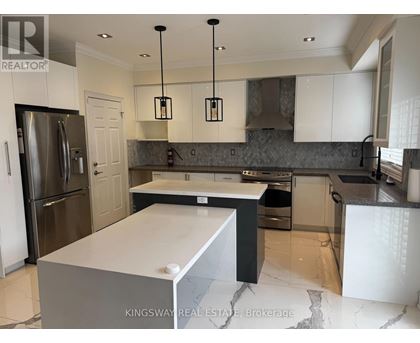 A modern kitchen with a large island in the center.