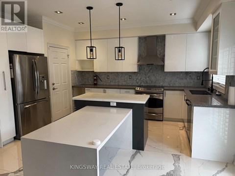 A modern kitchen with a large island in the center.