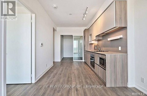 A modern kitchen with wooden cabinets and a central island.