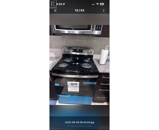 A black stove top oven with a blue drawer in front of it.