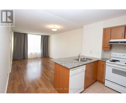 A kitchen with wooden cabinets and a granite countertop.