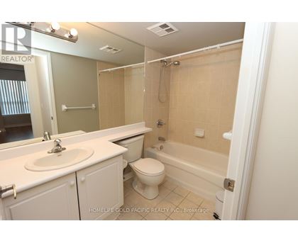 A bathroom with a sink, toilet and bathtub.