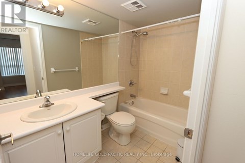 A bathroom with a sink, toilet and bathtub.