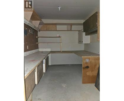A kitchen under construction with wooden cabinets and a countertop.