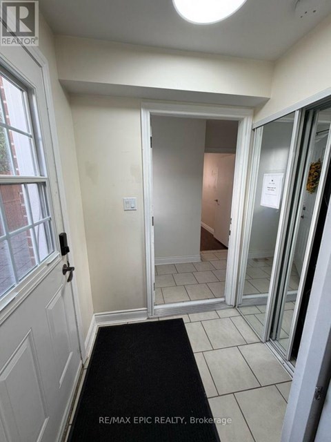 A hallway with a black mat on the floor.