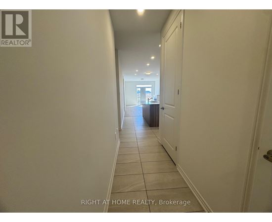 A hallway with a brokerage sign on the wall.