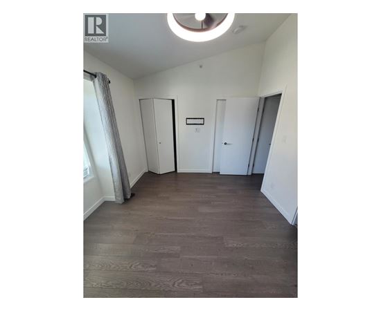 A room with a wooden floor and a white ceiling.