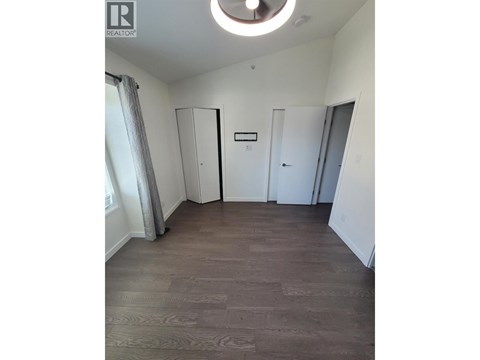A room with a wooden floor and a white ceiling.