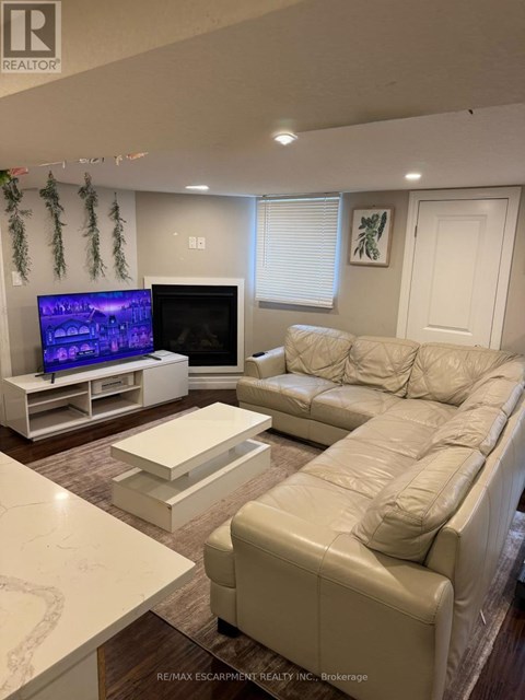 A living room with a white couch and a television.