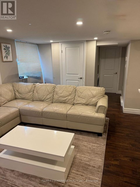 A living room with a white sofa and a coffee table.