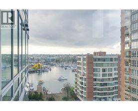 A view from a high-rise building looking out over a marina filled with boats.