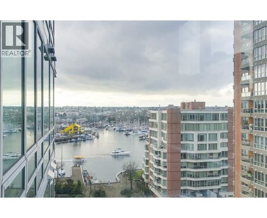 A view from a high-rise building looking out over a marina filled with boats.
