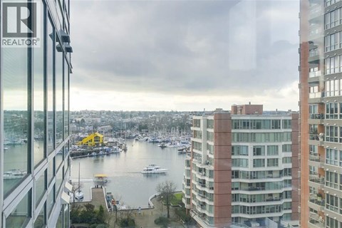 A view from a high-rise building looking out over a marina filled with boats.