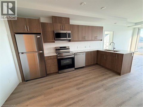 A kitchen with wooden cabinets and stainless steel appliances.