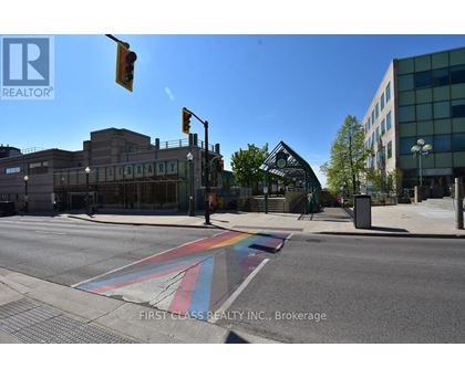 A street with a rainbow crosswalk in front of a library.