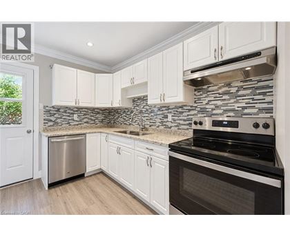 A kitchen with white cabinets and a black stove top oven.