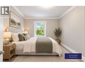 A well-lit bedroom with a large bed and a window showing greenery outside.