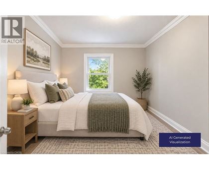 A well-lit bedroom with a large bed and a window showing greenery outside.