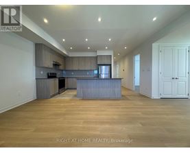 A spacious kitchen with wooden floors and a large island.