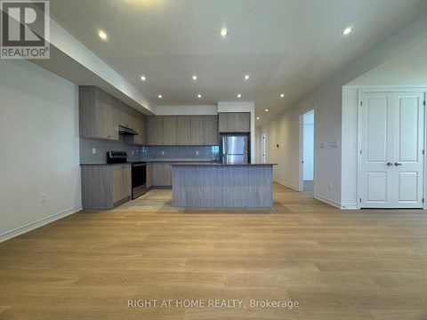 A spacious kitchen with wooden floors and a large island.