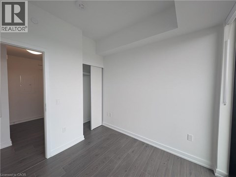 A black and white floor plan of a house with a balcony, dining room, kitchen, living room, terrace, and two bedrooms.